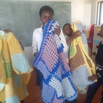 Children receiving blankets at Ditshego